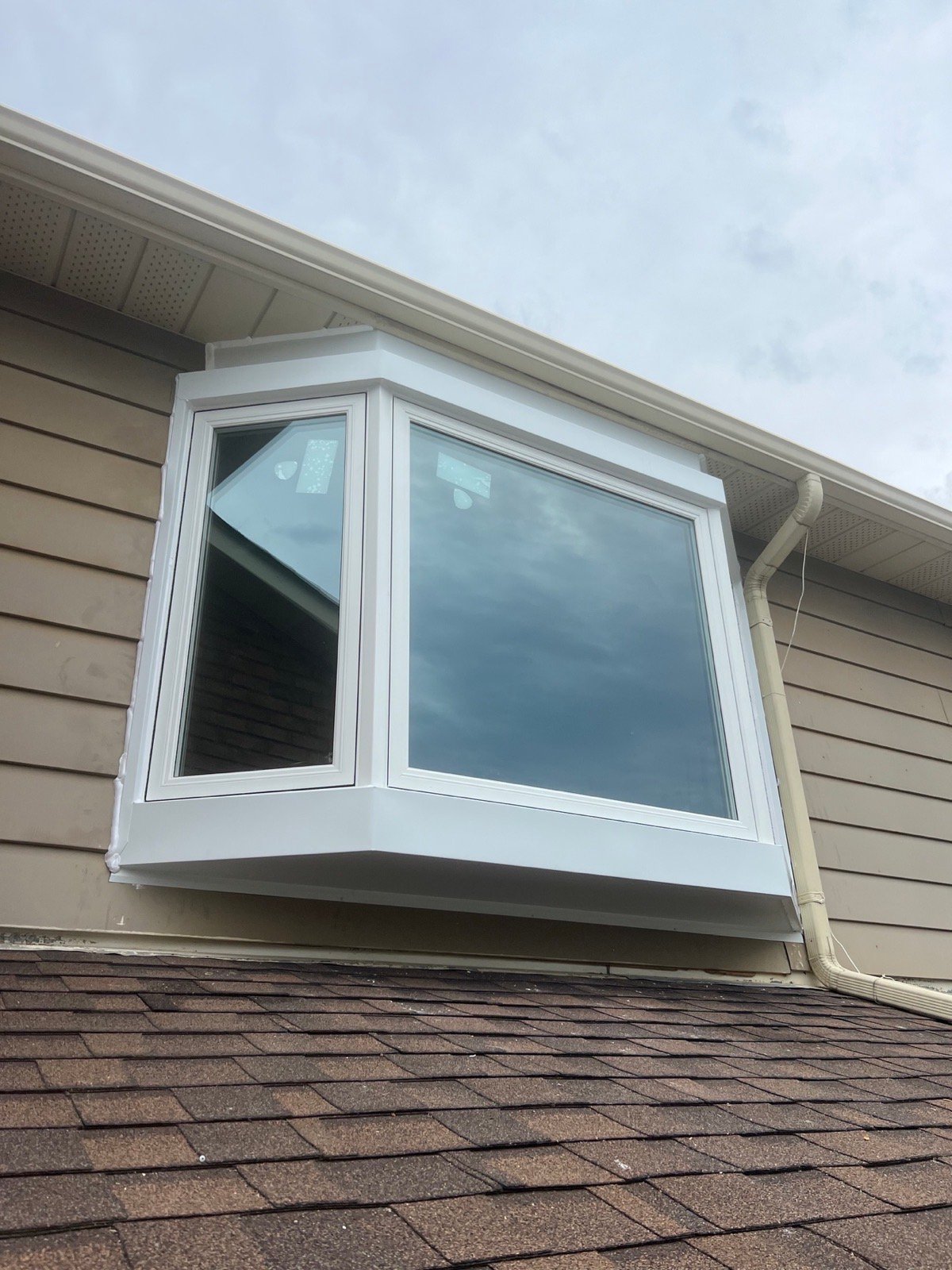 Finished white bay window rebuilt above a Brampton garage